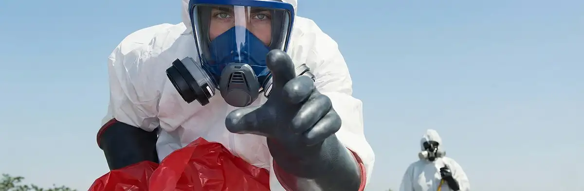 sewage clean up technician wearing protective gear handling biohazard materials in Sarasota, FL