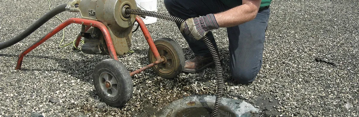 sewer rodding technician actively removing blockages from a sewer line in Sarasota, FL