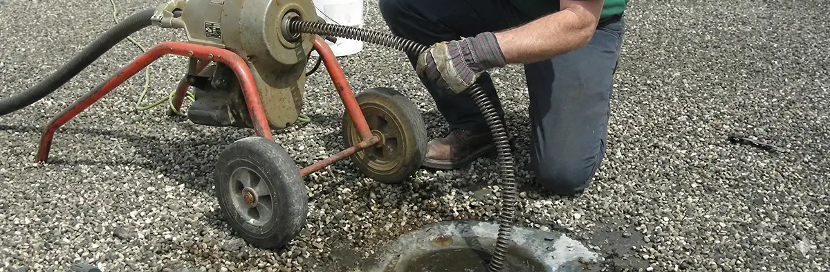 sewer rodding technician actively removing blockages from a sewer line in Sarasota, FL