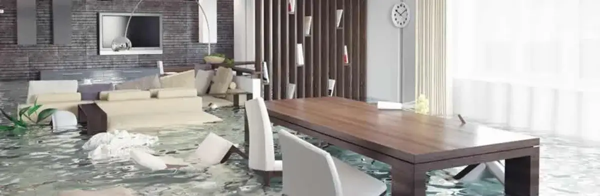 home interior affected by water damage with flooded floors and displaced furniture in Sarasota, FL
